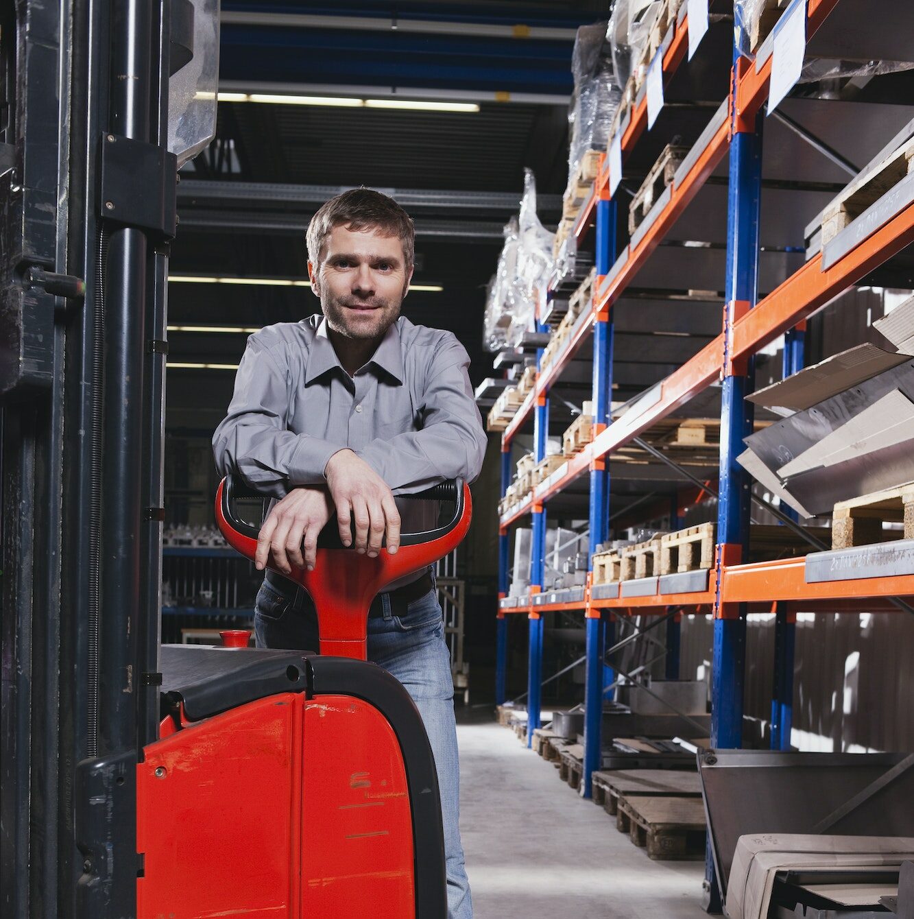 Germany, Neukirch, Foreman leaning on forklift truck, portrait