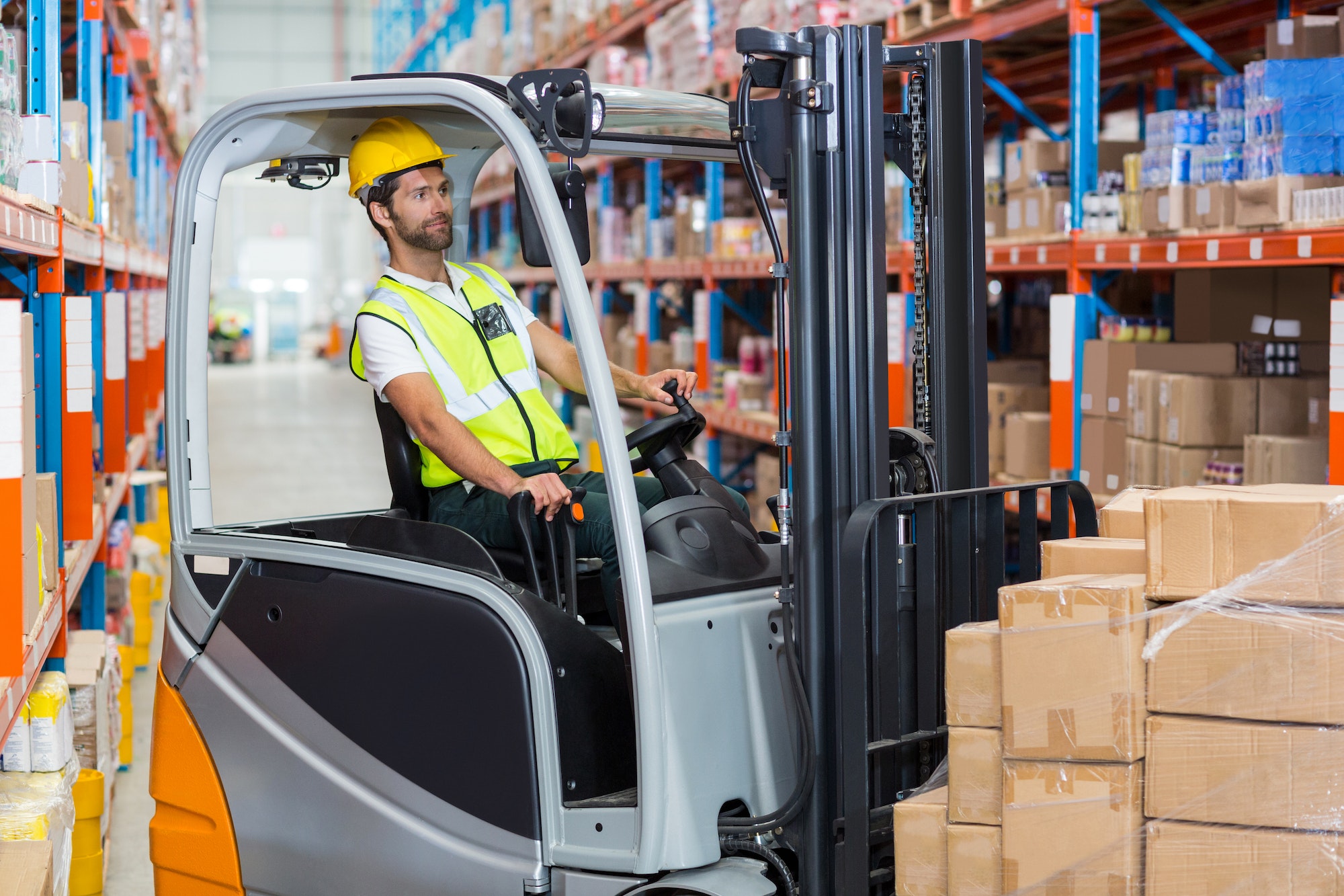 Male worker using forklift