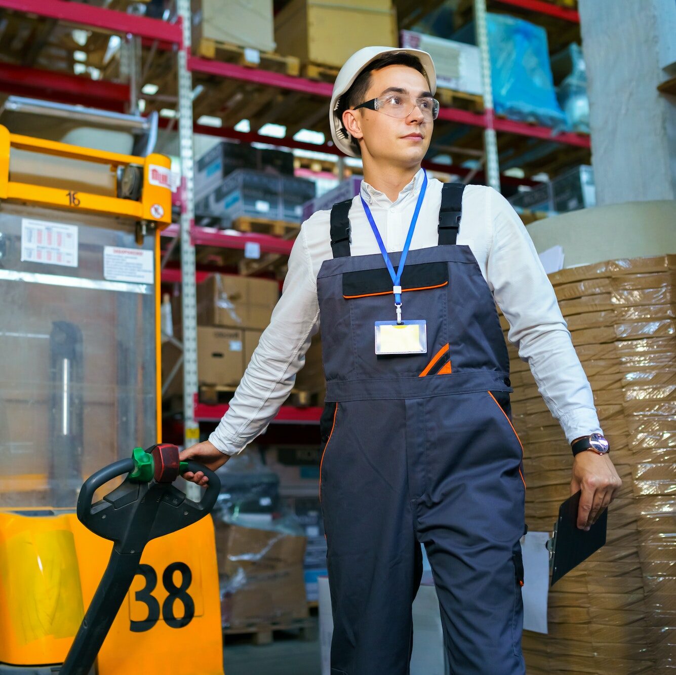 Man works in a warehouse with a forklift